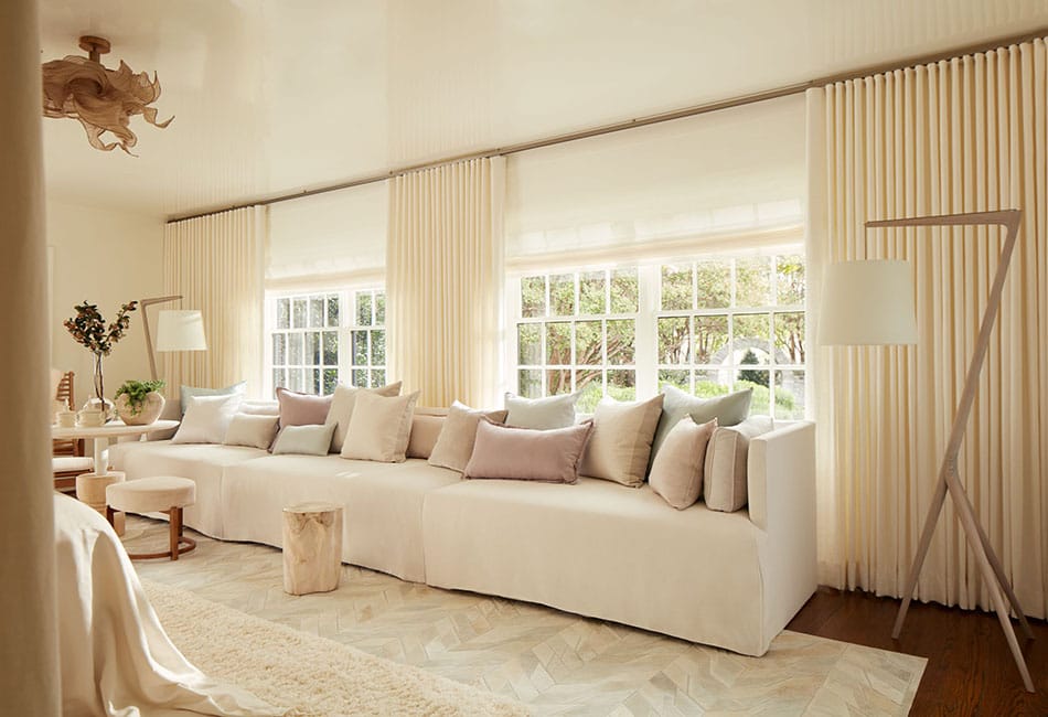 Sunlit living room with ivory drapery and soft linen sofa